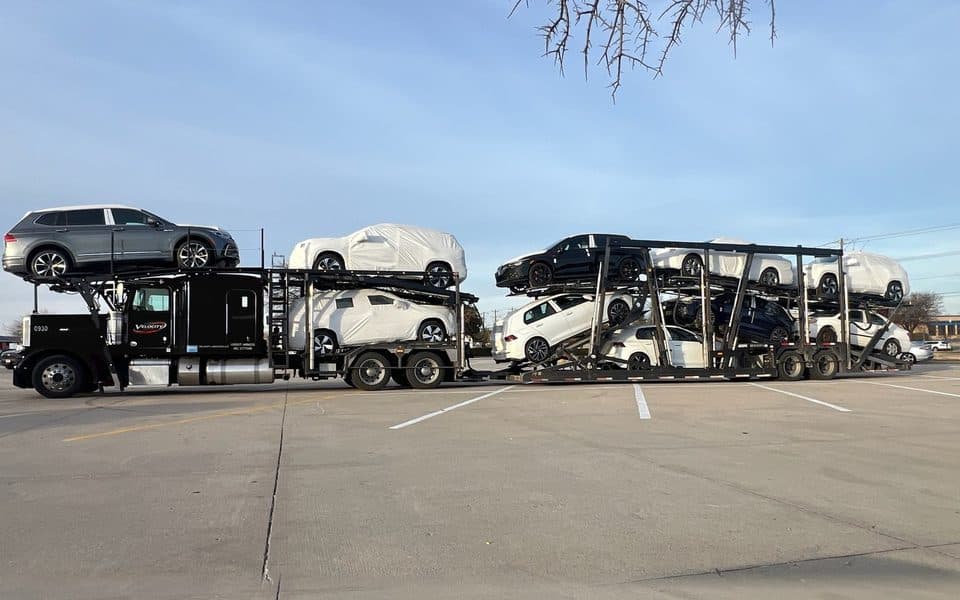 Velocity Logistics Peterbilt and 8-car trailer loaded with new dealer cars
