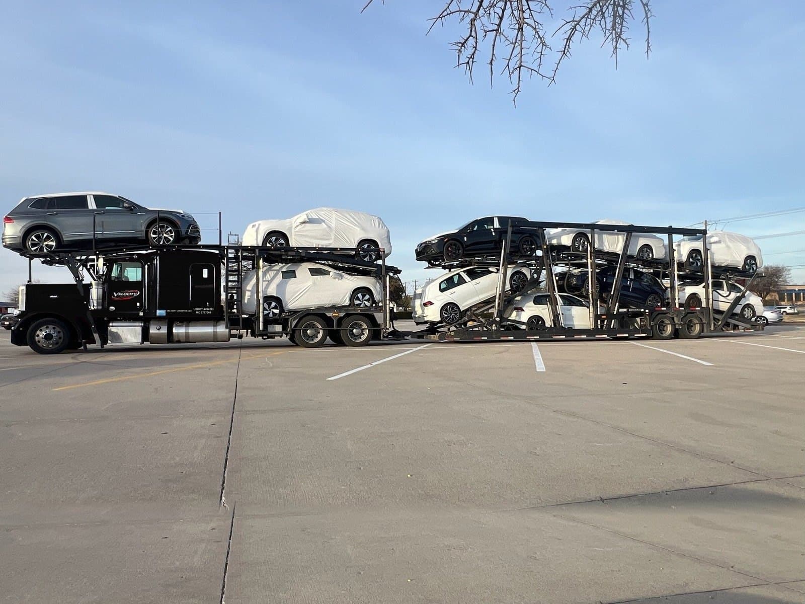 Velocity Logistics Peterbilt with a loaded car trailer