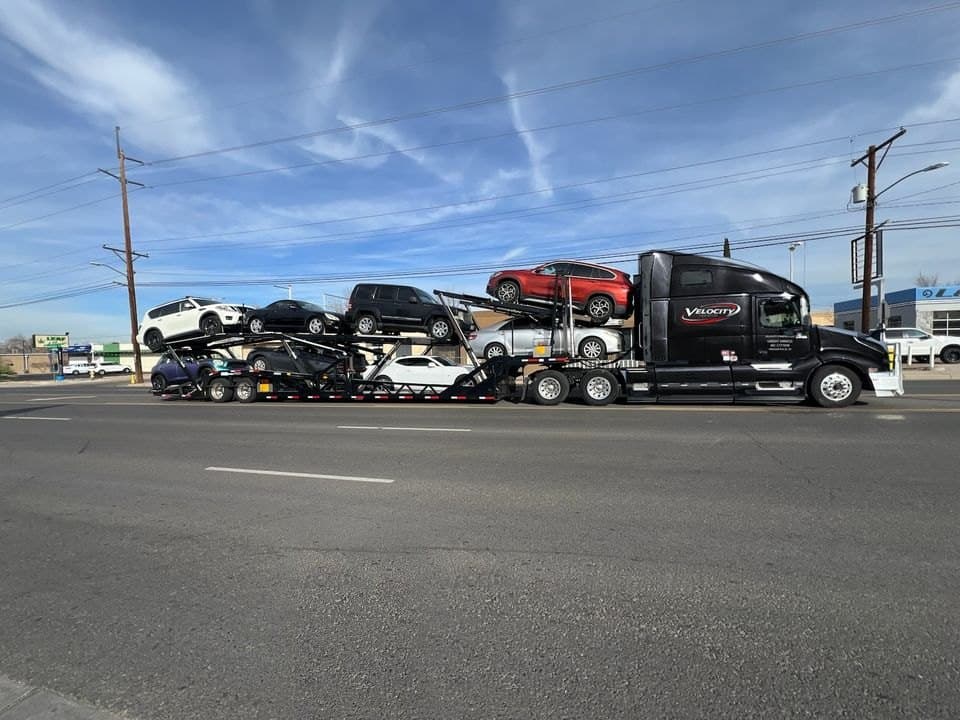 Velocity Logistics semi car hauler loaded with cars on both decks