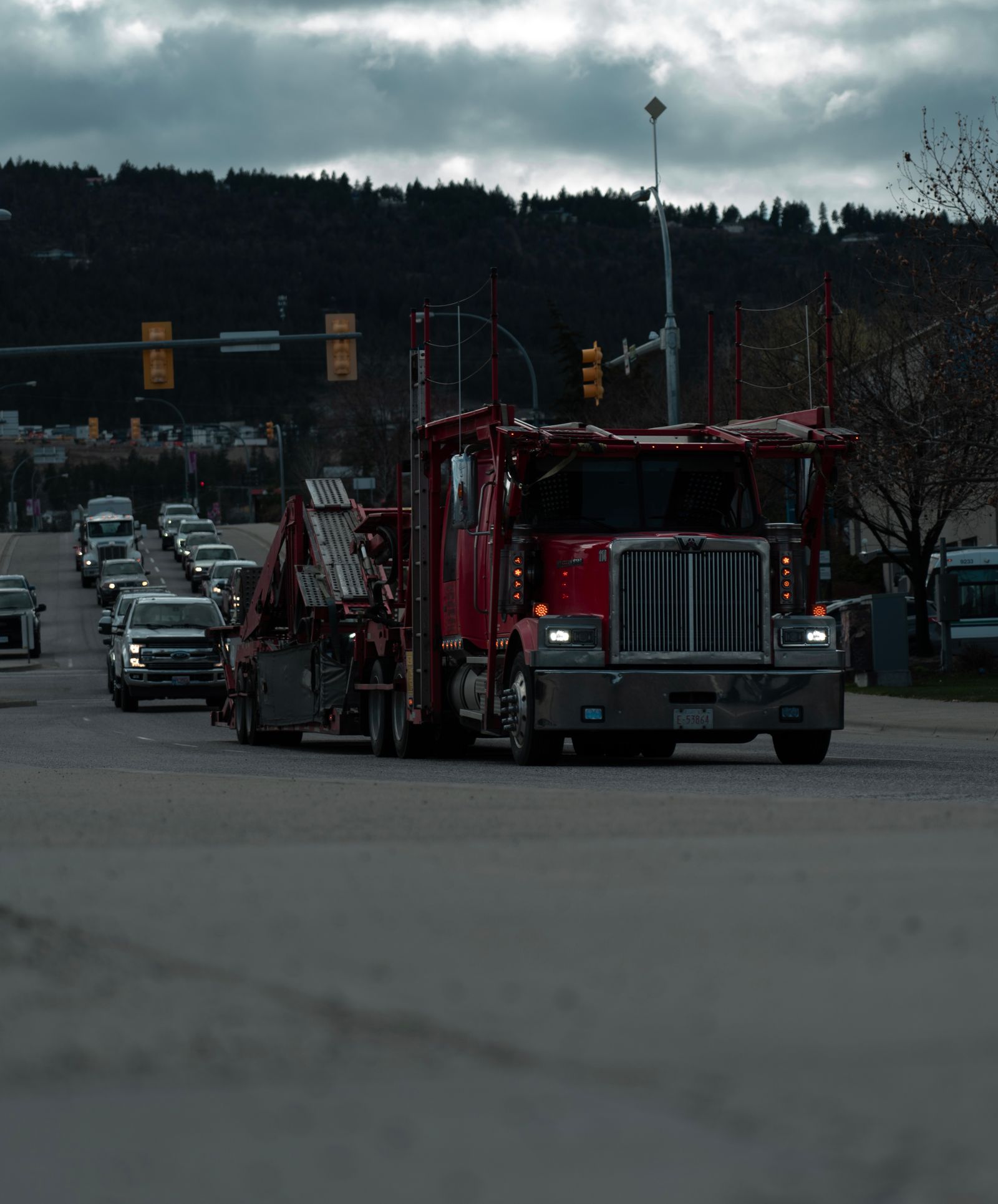 A car transport carrier making its way through town — the kind of operation worth vetting before you book